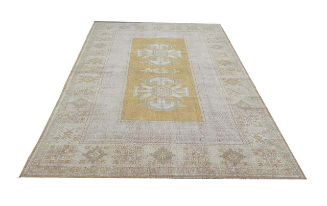 Vintage Handmade Turkish Rug with muted yellow tones and pale blue accents throughout the traditional border pattern. Dated from the 1960's. Traditional Vintage Turkish Rug available in Melbourne