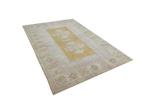 Vintage Handmade Turkish Rug with muted yellow tones and pale blue accents throughout the traditional border pattern.  Dated from the 1960's.  Traditional Vintage Turkish Rug available in Melbourne 