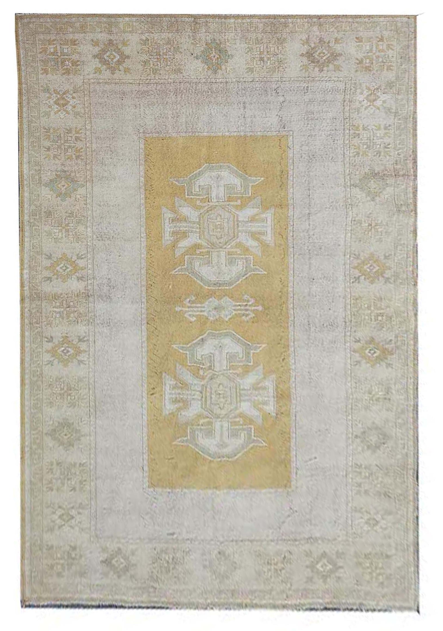 Vintage Handmade Turkish Rug with muted yellow tones and pale blue accents throughout the traditional border pattern.  Dated from the 1960's.  Traditional Vintage Turkish Rug available in Melbourne 