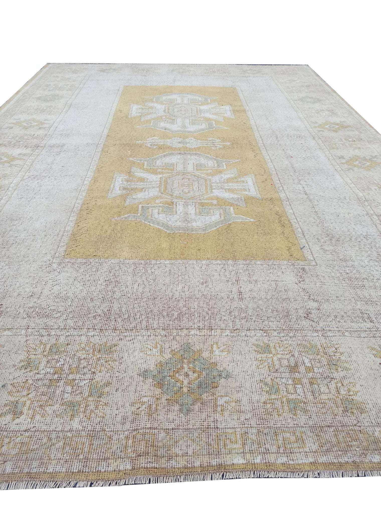 Vintage Handmade Turkish Rug with muted yellow tones and pale blue accents throughout the traditional border pattern.  Dated from the 1960's.  Traditional Vintage Turkish Rug available in Melbourne 