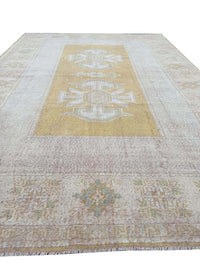 Vintage Handmade Turkish Rug with muted yellow tones and pale blue accents throughout the traditional border pattern.  Dated from the 1960's.  Traditional Vintage Turkish Rug available in Melbourne 