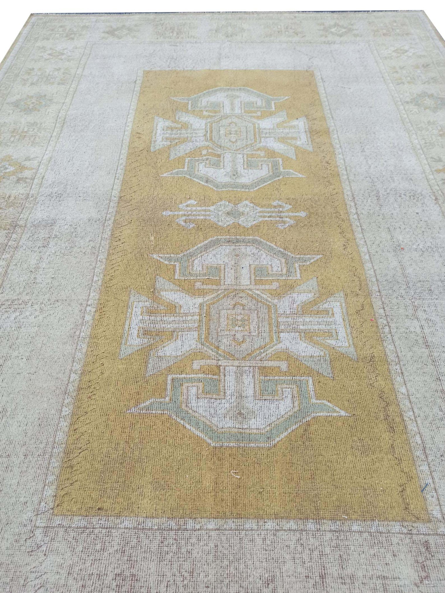 Vintage Handmade Turkish Rug with muted yellow tones and pale blue accents throughout the traditional border pattern.  Dated from the 1960's.  Traditional Vintage Turkish Rug available in Melbourne 