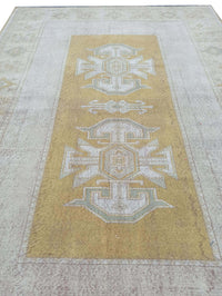 Vintage Handmade Turkish Rug with muted yellow tones and pale blue accents throughout the traditional border pattern.  Dated from the 1960's.  Traditional Vintage Turkish Rug available in Melbourne 