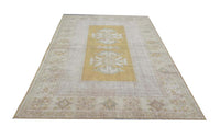 Vintage Handmade Turkish Rug with muted yellow tones and pale blue accents throughout the traditional border pattern.  Dated from the 1960's.  Traditional Vintage Turkish Rug available in Melbourne 